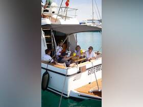 A lively group enjoys cocktails and laughter aboard a yacht, celebrating together in a picturesque setting — perfect for memorable outings with friends.