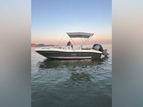 A sleek speedboat captured at sunset, showcasing its elegant design and tranquil surroundings on the water.