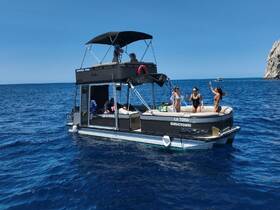 A lively group enjoys a fun day on a pontoon boat, celebrating under the sun with friends in the beautiful blue waters.