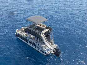 Aerial view of a stylish pontoon boat gliding through crystal-clear waters, featuring a slide and spacious seating, perfect for family outings or fun on the water.