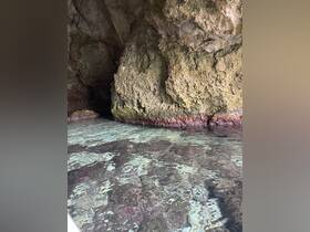 An unclear view of rocky formations and water, lacking identifiable features or subjects.