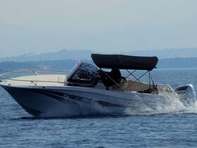 A sleek speedboat glides through calm waters, showcasing its elegant design and performance — perfect for thrilling adventures on the sea.