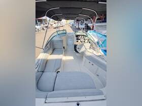 Interior view of a well-appointed boat cabin featuring comfortable seating and a helm, perfect for relaxing and navigating on the water.