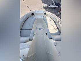 Interior view of a boat's seating area, showcasing comfortable cushions and a clean helm space, perfect for relaxing on the water.