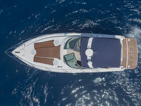 Aerial view of a sleek speedboat gliding through deep blue waters, showcasing its elegant design and spacious deck — perfect for luxury outings on the water.
