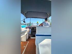 A view from the helm of a boat featuring a child and an adult, showcasing the comfortable interior space and seating arrangements, perfect for family outings on the water.