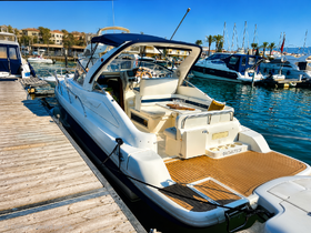 A sleek yacht docked at a marina, showcasing its elegant design and spacious deck, perfect for leisurely outings on the water.