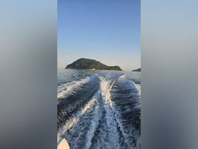 A scenic view of an island from a boat, showcasing the tranquil waters and beautiful landscape — perfect for adventure seekers and nature lovers.