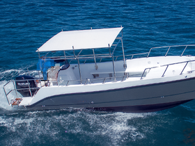 A sleek speedboat glides through the vibrant blue waters, showcasing its elegant design and performance capabilities.