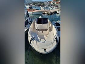 A clear view of a boat docked at the marina, showcasing its sleek design and structure — ideal for boating enthusiasts and potential charters.