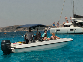 A lively group enjoys a day on the water aboard a motorboat, capturing the essence of summer fun and adventure in a picturesque setting.