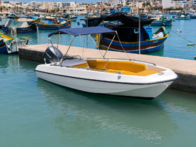 A sleek speedboat docked in a vibrant harbor, showcasing its bright yellow interior against the turquoise waters — perfect for day trips or leisure outings.