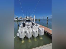 A powerful speedboat equipped with multiple fishing rods, docked and ready for an exciting day on the water.