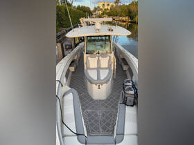 An interior view of a well-equipped boat showcasing comfortable seating and a modern helm, perfect for a day on the water.