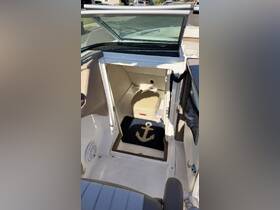 Interior view of a boat cabin featuring a cozy anchor-themed mat and storage area, perfect for keeping essentials organized while on the water.