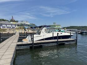 A sleek speedboat docked at a marina, showcasing the vibrant waterfront atmosphere perfect for summer outings.