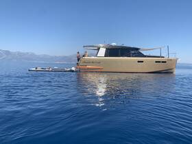 A lively group enjoys a sunny day on the water, with some swimming near a stylish boat — perfect for summer adventures and relaxation.