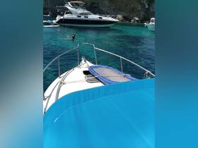 A snorkeler enjoys the clear turquoise waters while several boats are anchored nearby, creating a perfect backdrop for a day of adventure on the water.