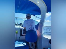 A view from inside a boat's helm, showcasing the captain steering while enjoying a sunny day on the water. Perfect for those interested in boat trips and charters.