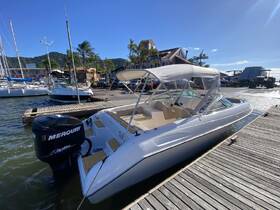 A sleek speedboat docked at a marina, showcasing its elegant design and powerful Mercury engine, perfect for thrilling water adventures.
