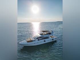 A stunning aerial view of a luxurious yacht cruising through serene waters, perfect for memorable day trips or sunset cruises.