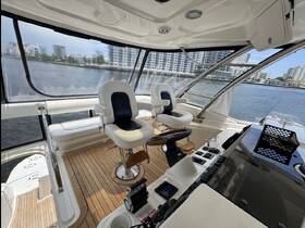 A well-appointed helm area inside a luxury boat, featuring comfortable seating and a sleek design, perfect for navigating the waters in style.