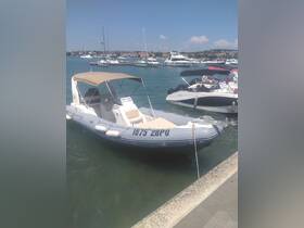 A sleek speedboat docked in a marina, showcasing its design against a backdrop of other vessels and a clear blue sky.