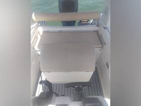 Interior view of a boat's helm and seating area, showcasing the clean and functional design ideal for navigation and comfort on the water.