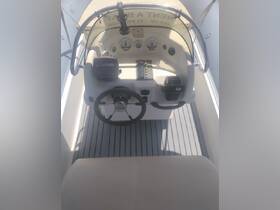 An overhead view of the helm and console area inside a rental boat, showcasing the steering wheel and control panel — ideal for navigating the waters.