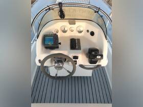 A detailed view of the helm and console area inside a boat, showcasing essential navigation equipment and controls for an enjoyable boating experience.