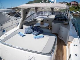 A beautifully designed interior of a boat featuring comfortable seating and a stylish lounge area, perfect for relaxation on the water.