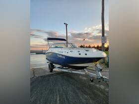 A sleek SeaRay boat named 'SeaWeed' is docked at the ramp, ready for a day on the water against a picturesque sunset backdrop.