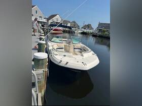 A sleek speedboat docked at a marina, showcasing its stylish design and inviting seating, perfect for summer outings on the water.
