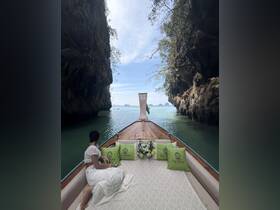 A serene view from the deck of a boat, showcasing stunning rock formations and tranquil waters, perfect for a relaxing day on the sea.