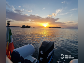 A serene sunset view from a boat, showcasing the tranquil waters and distant islands — perfect for peaceful evening cruises.