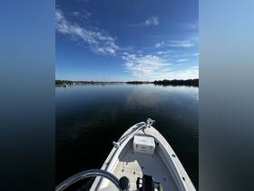 A serene view from the front of a speedboat, gliding through calm waters under a clear blue sky — perfect for a day of exploration on the water.