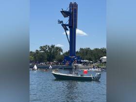 A lively scene at a water sports event featuring a boat in the foreground and a diving platform in the background, showcasing the excitement of summer activities.
