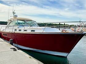 A striking red yacht docked at the marina, showcasing its sleek design and modern features — perfect for luxury outings on the water.