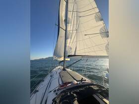 A stunning view of a sailboat underway, showcasing its sails against a clear sky and shimmering waters — perfect for sailing enthusiasts and adventure seekers.