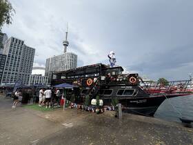 A lively scene at the dock featuring the 'Island Princess' boat, with guests gathered around, perfect for celebrations and events on the water.