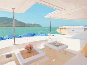 A bright and inviting interior view of a boat's lounge area, featuring a cozy seating arrangement and a decorative flower arrangement, perfect for relaxing while enjoying scenic views.