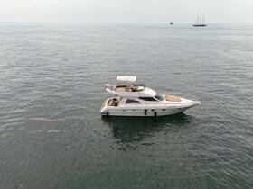 Aerial view of a luxurious yacht cruising through calm waters, showcasing its elegant design and spacious deck, perfect for leisurely outings.