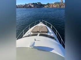 A stunning view from the front of a yacht, showcasing the sleek design and comfortable sunbathing area, perfect for enjoying the open water.