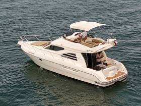 A sleek yacht named 'Clara Vittoria' is docked on calm waters, showcasing its elegant design and spacious upper deck.