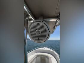 A close-up of a JL Audio speaker mounted on a boat, showcasing onboard audio amenities for an enhanced cruising experience.