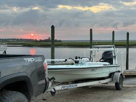 A serene sunset view featuring a boat docked at the water's edge, creating a picturesque scene perfect for evening outings.