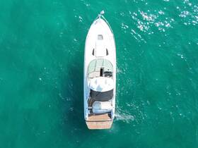 Aerial view of a sleek yacht gliding through vibrant turquoise waters, showcasing its elegant design and perfect for luxury outings.