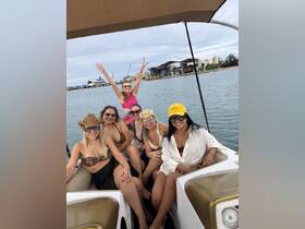A lively group of friends enjoys a fun day on the water, celebrating together on a boat — perfect for unforgettable moments and adventures.