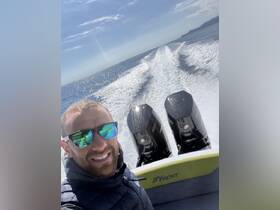 A thrilling selfie taken aboard a speedboat, showcasing the excitement of a day on the ocean with powerful engines in view.