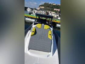 A view of the stylish seating area on a modern boat, showcasing comfortable cushions and a sleek design, perfect for relaxing on the water.